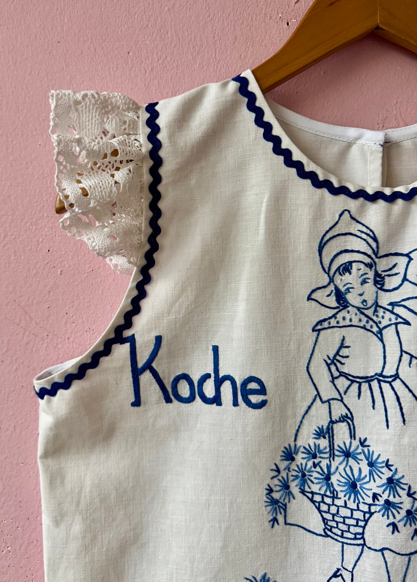 White top with blue hand embroidery