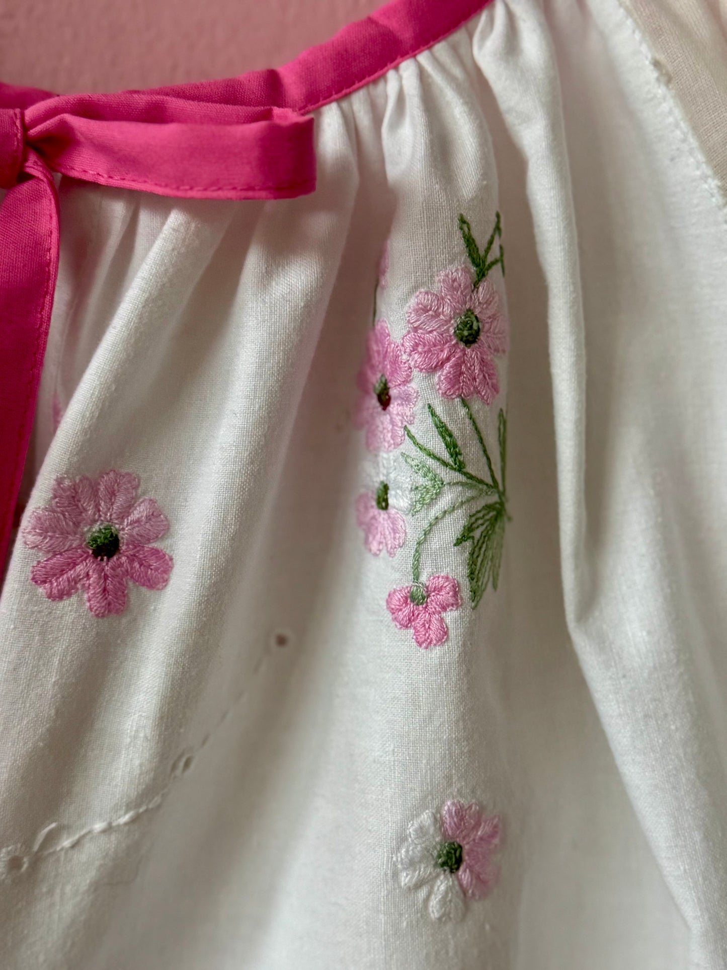 White blouse with pink binding