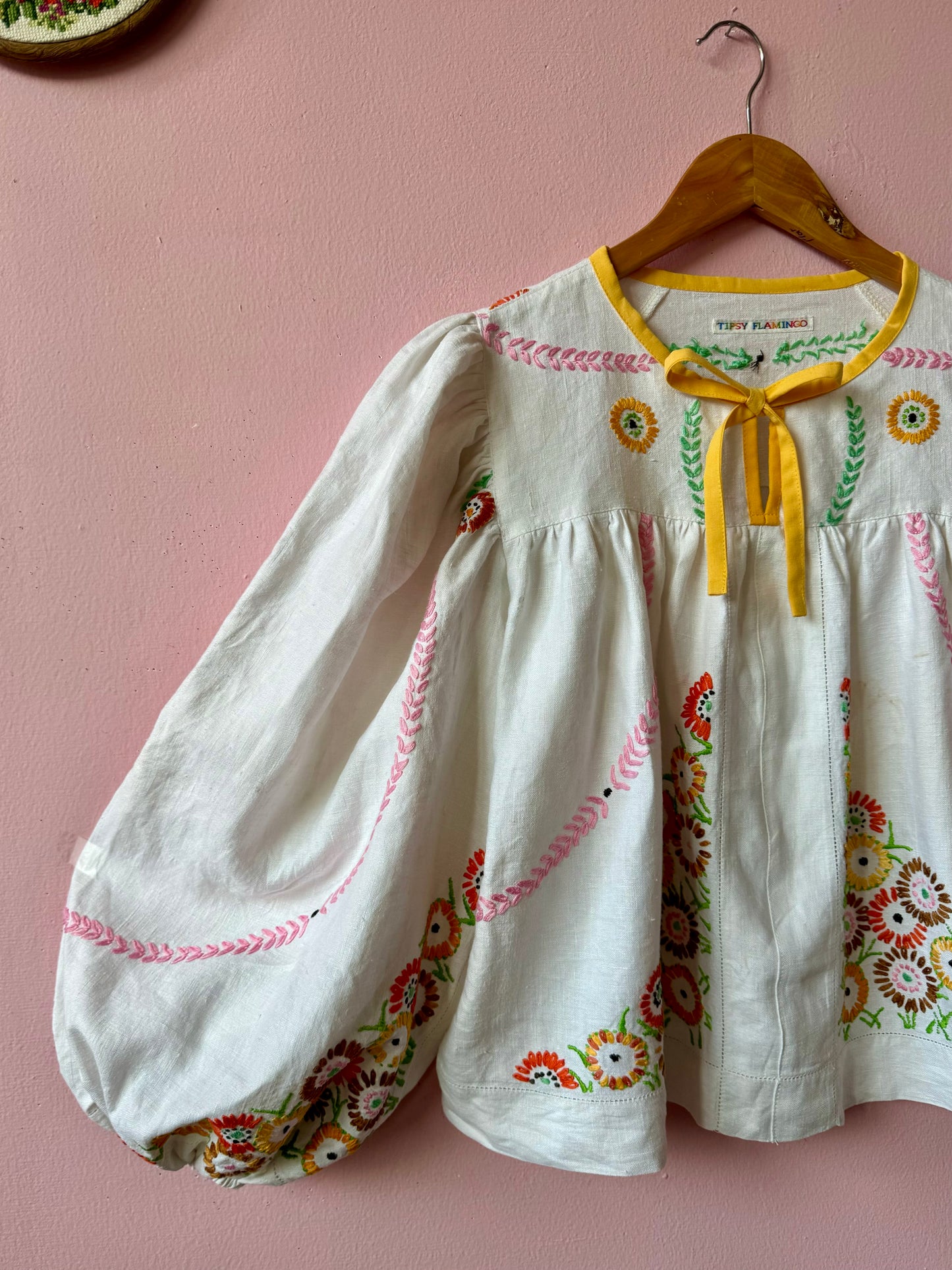 Linen blouse with floral embroidery and yellow binding