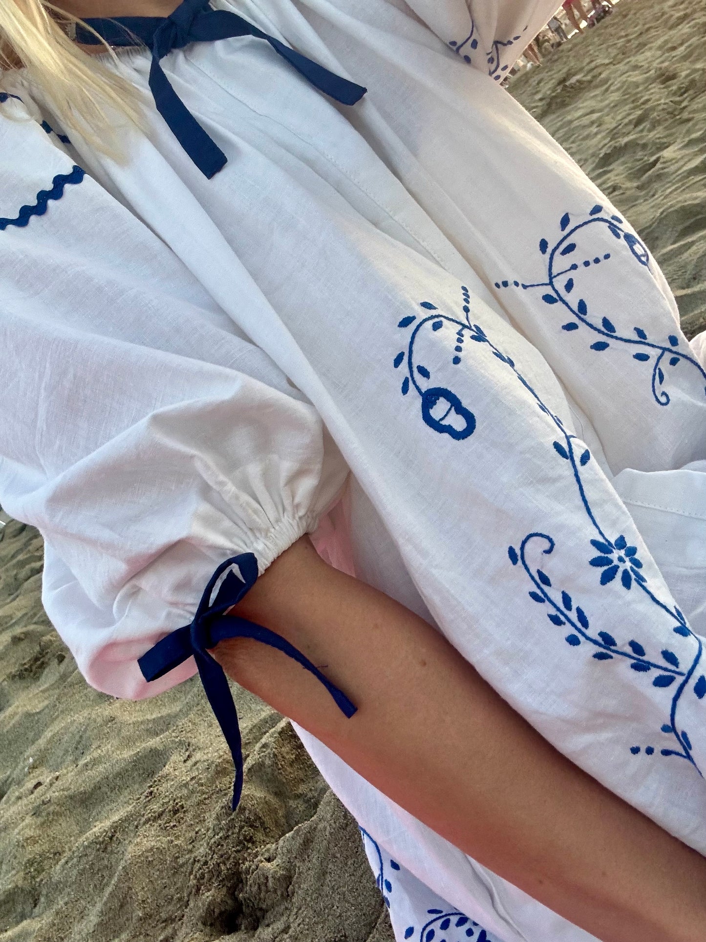 White mini dress with blue embroidery and blue bows