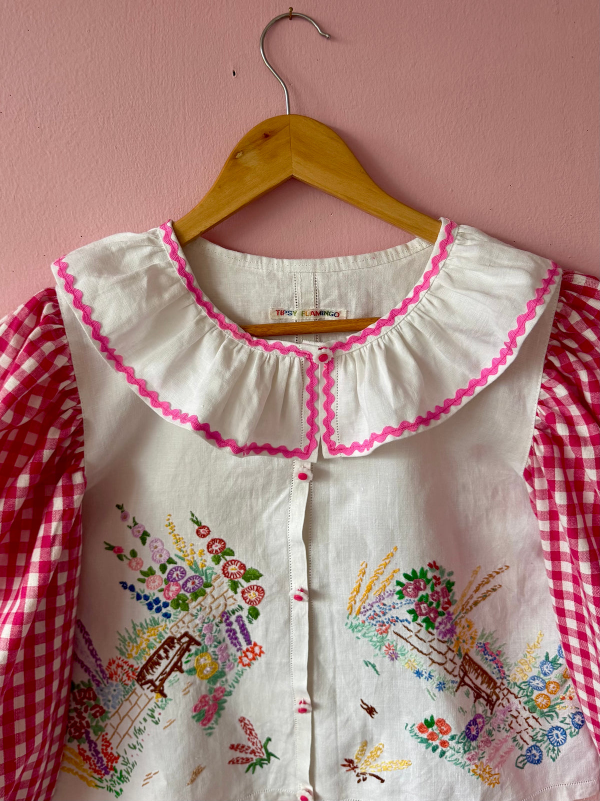 Pink gingham and floral blouse with neckline frill