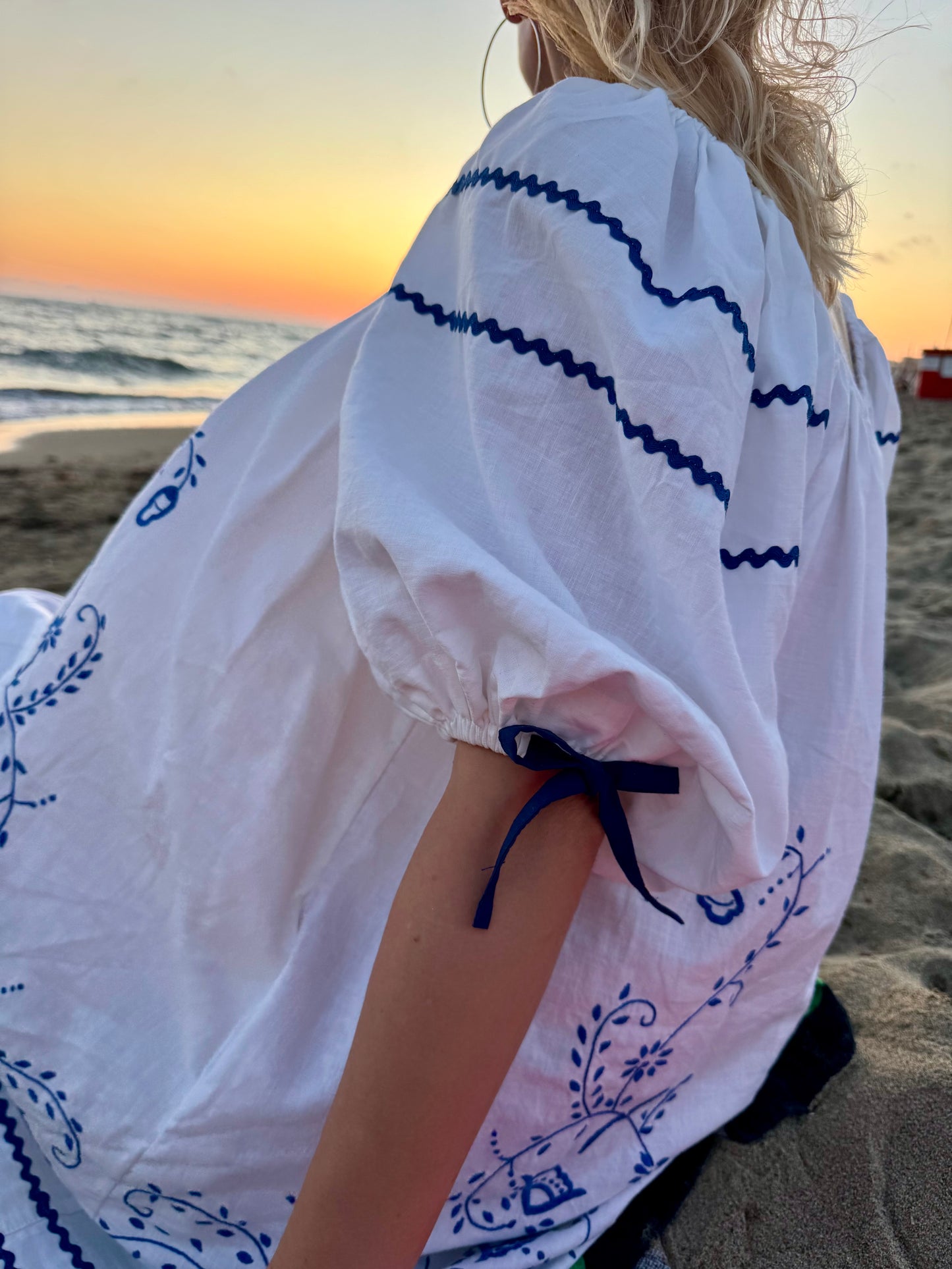White mini dress with blue embroidery and blue bows