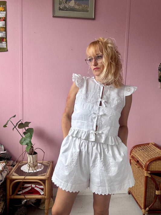 All white shorts with hand embroidery and ric rac