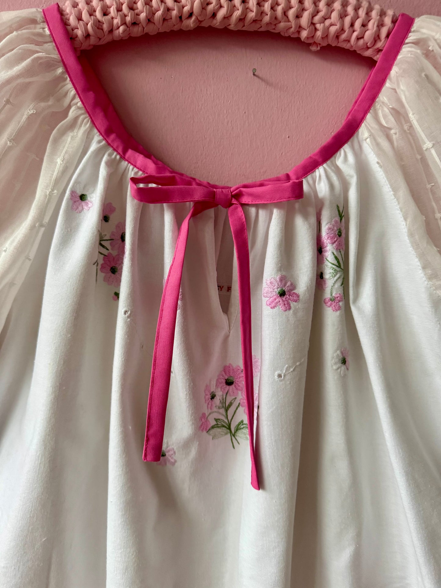 White blouse with pink binding