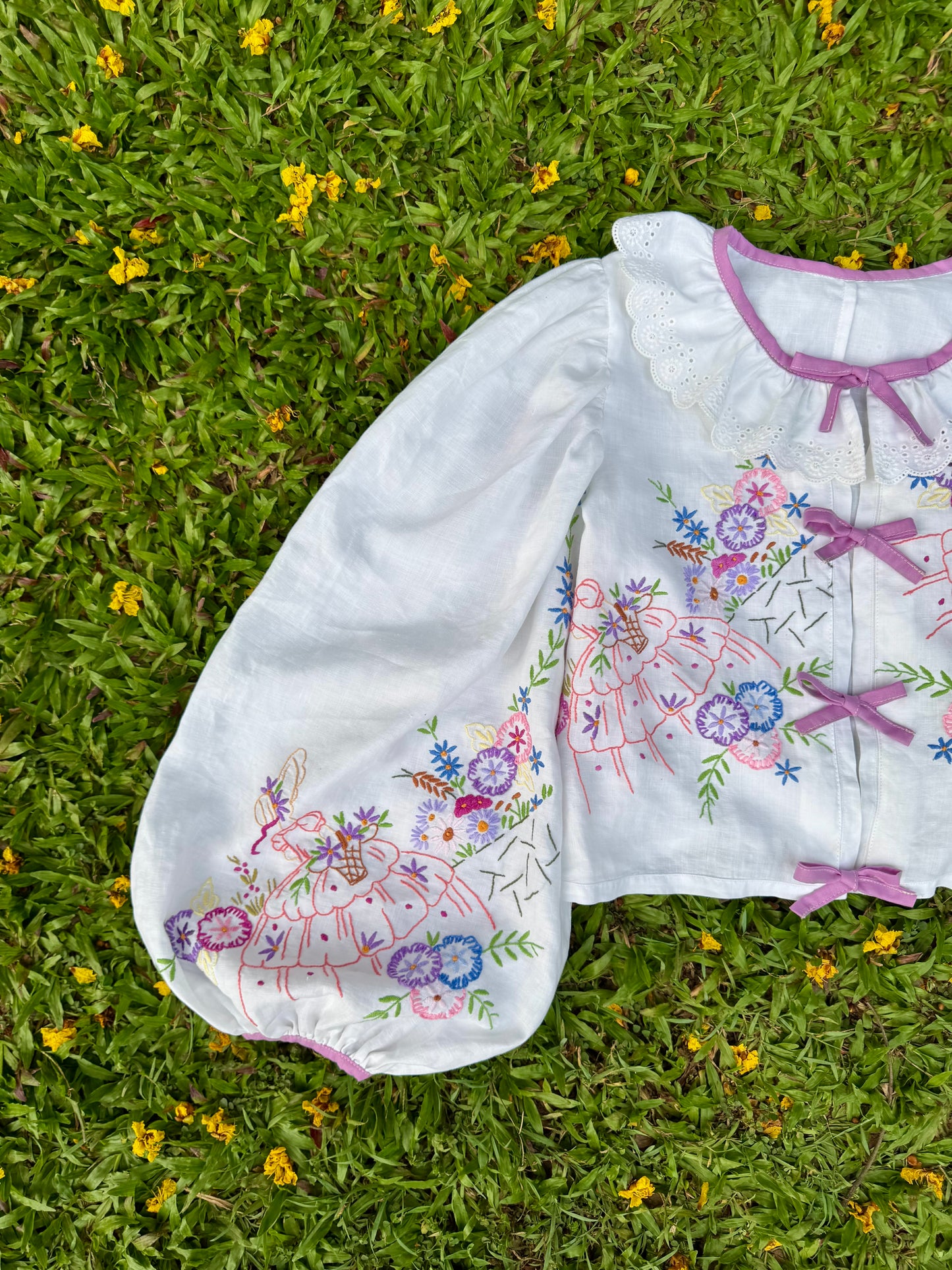 Blouse with lace neckline and lilac trimming