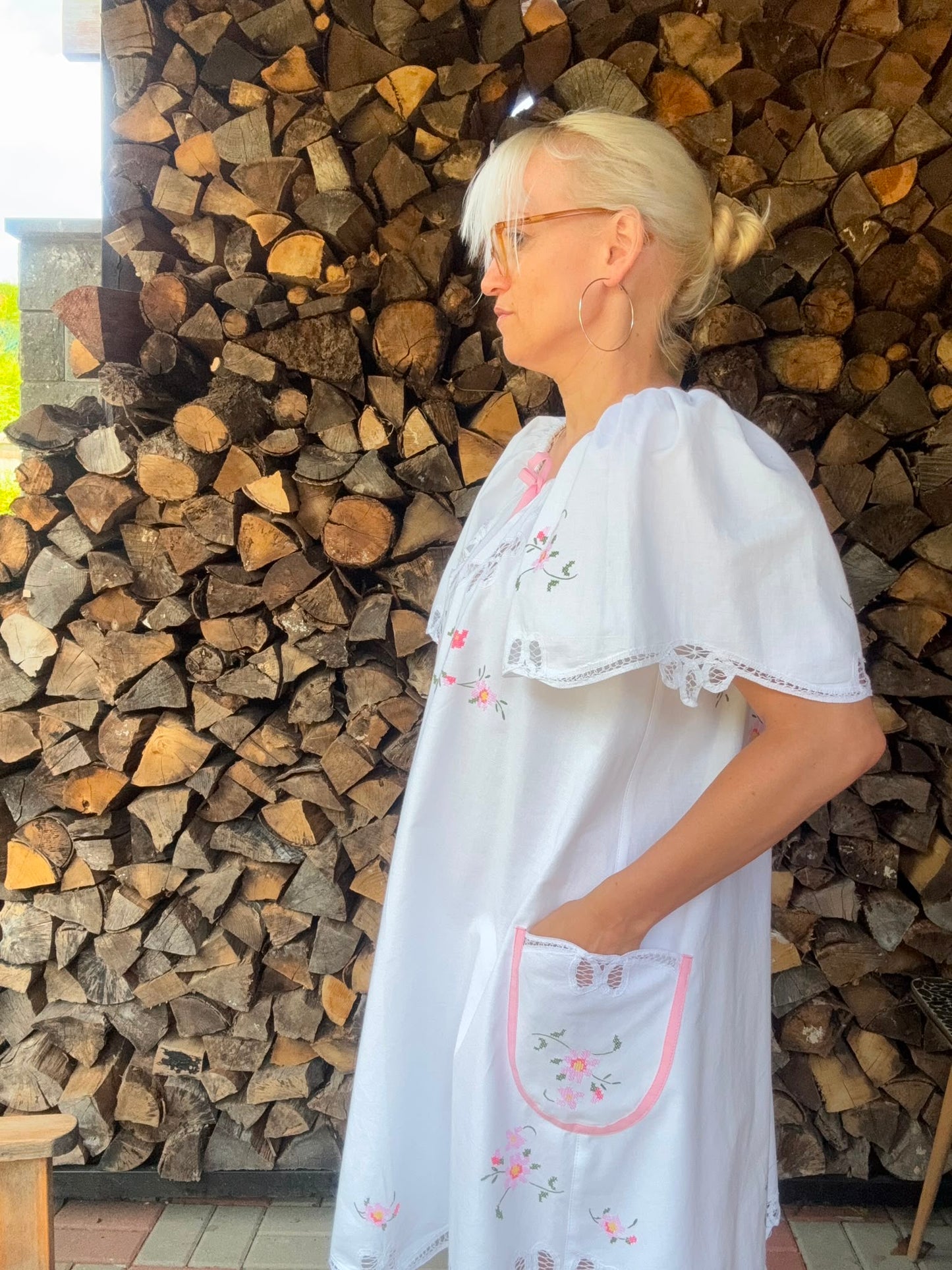 White dress with pink bow and pink cross stitching flowers