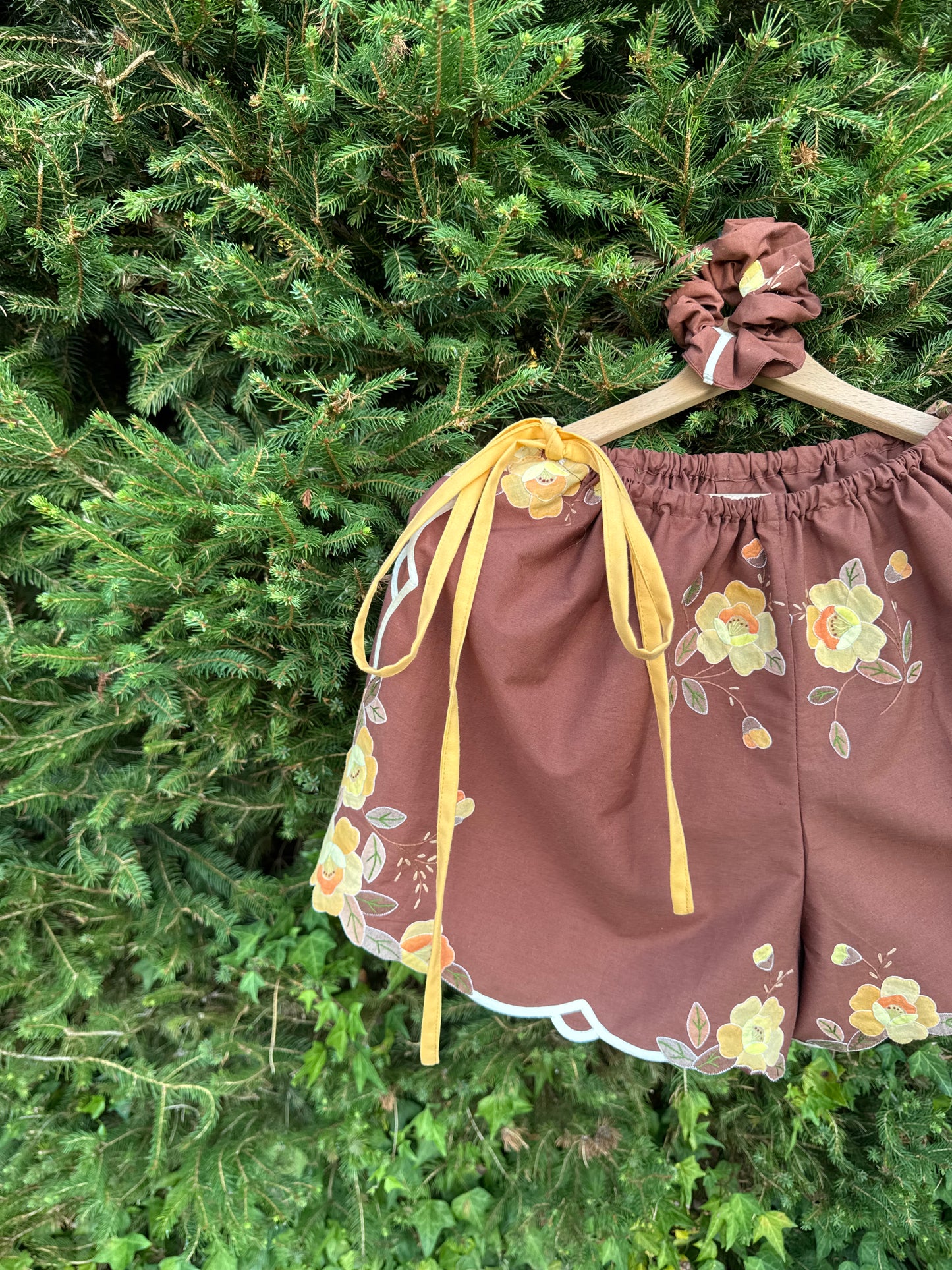 Brown shorts with yellow side straps