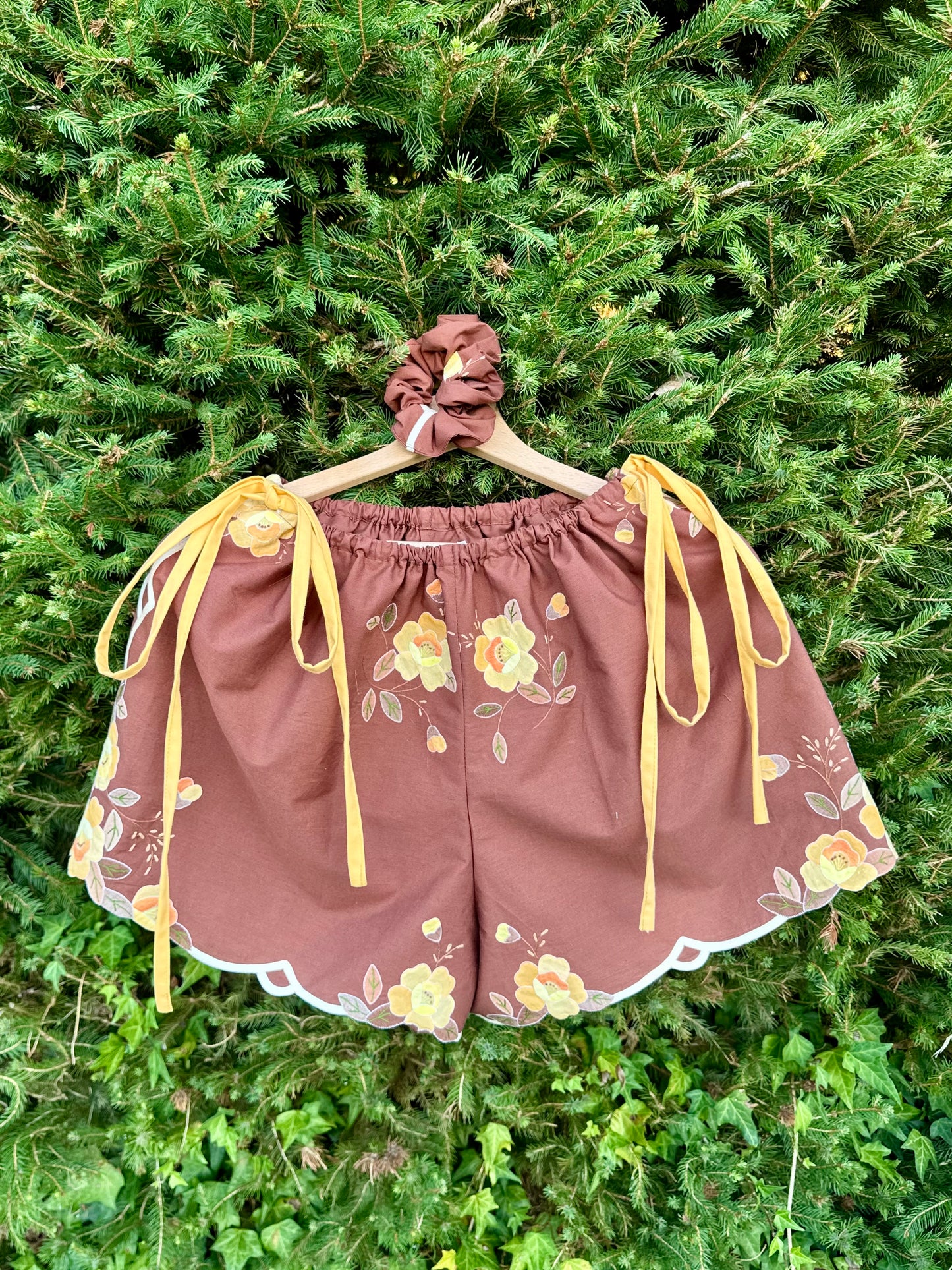 Brown shorts with yellow side straps