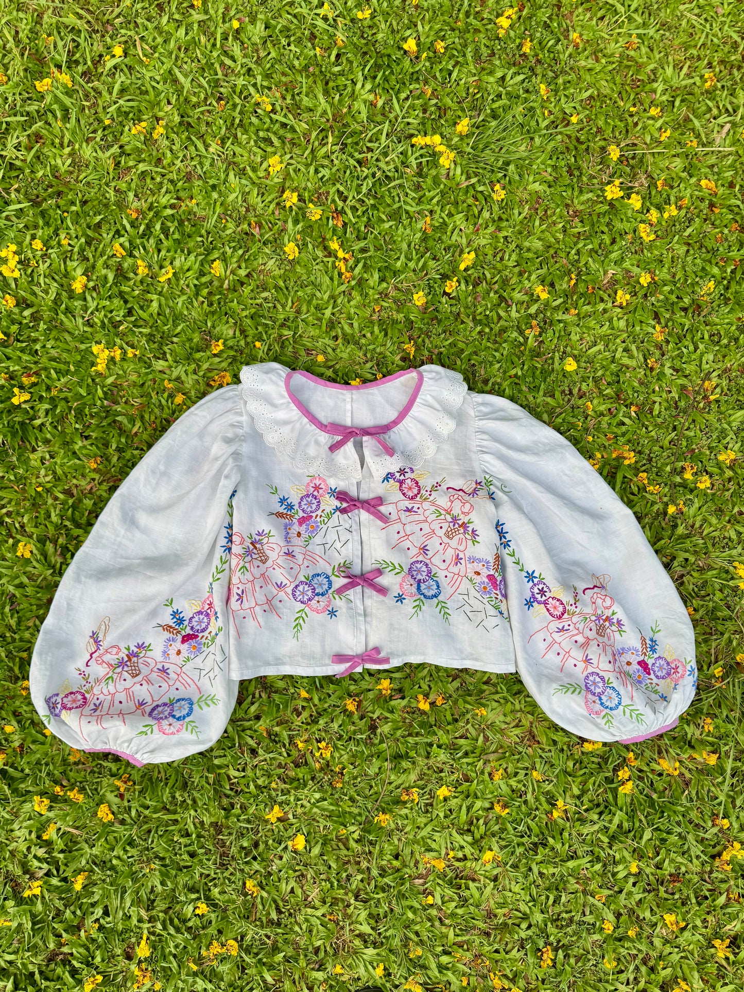 Blouse with lace neckline and lilac trimming