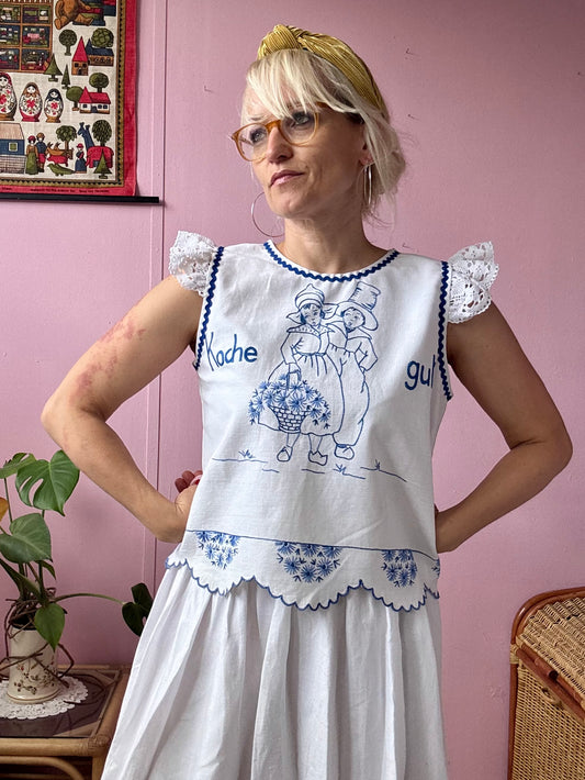 White top with blue hand embroidery