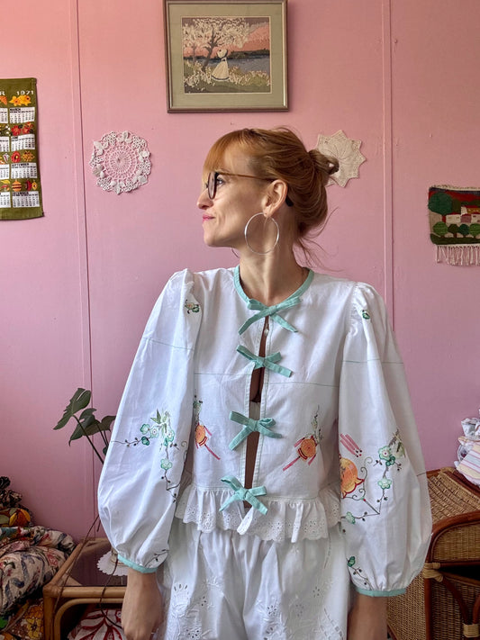 Embroidery and appliqués blouse with light green bows