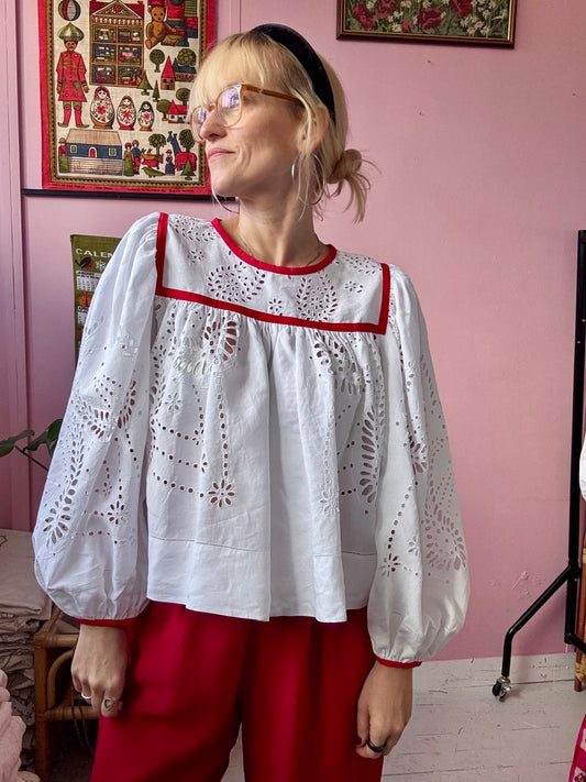 White blouse with red binding