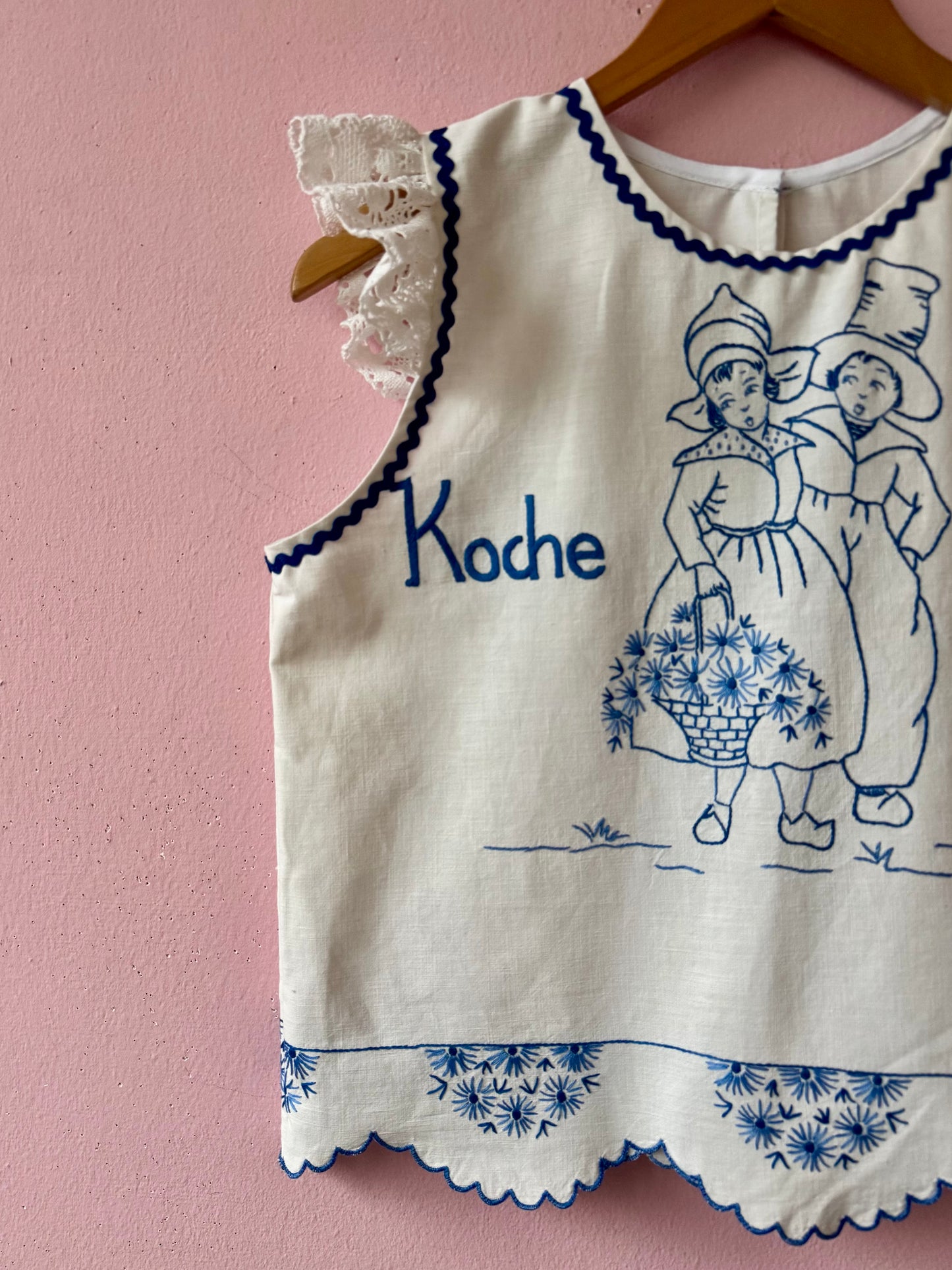 White top with blue hand embroidery