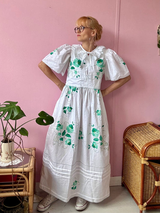 White maxi dress with green floral appliqués
