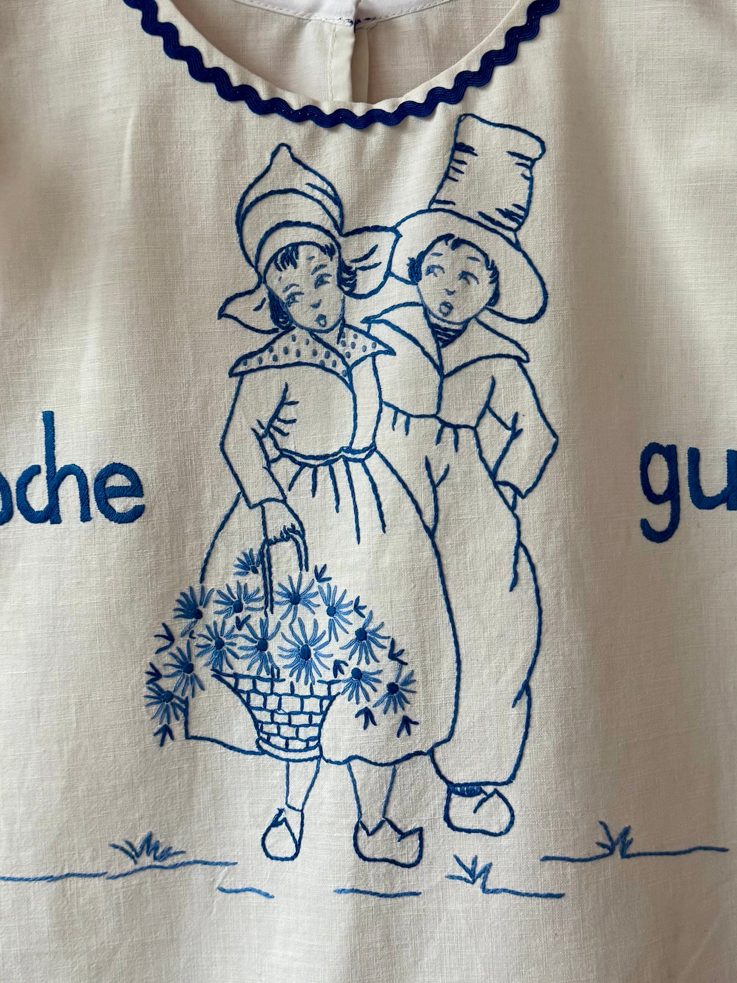 White top with blue hand embroidery