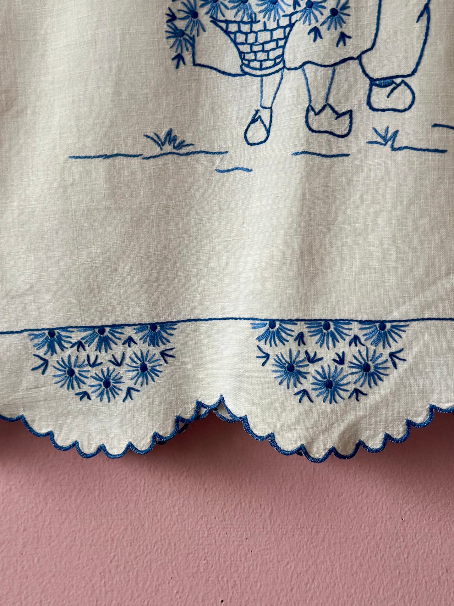 White top with blue hand embroidery