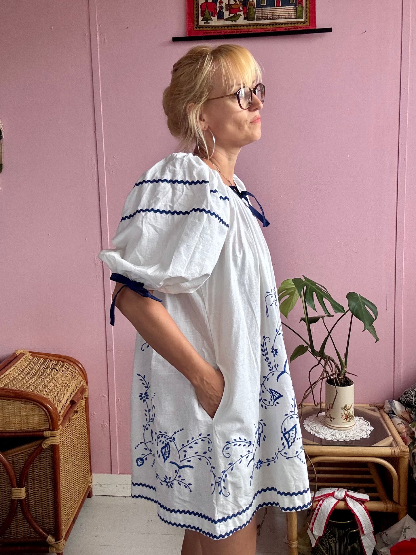 White mini dress with blue embroidery and blue bows