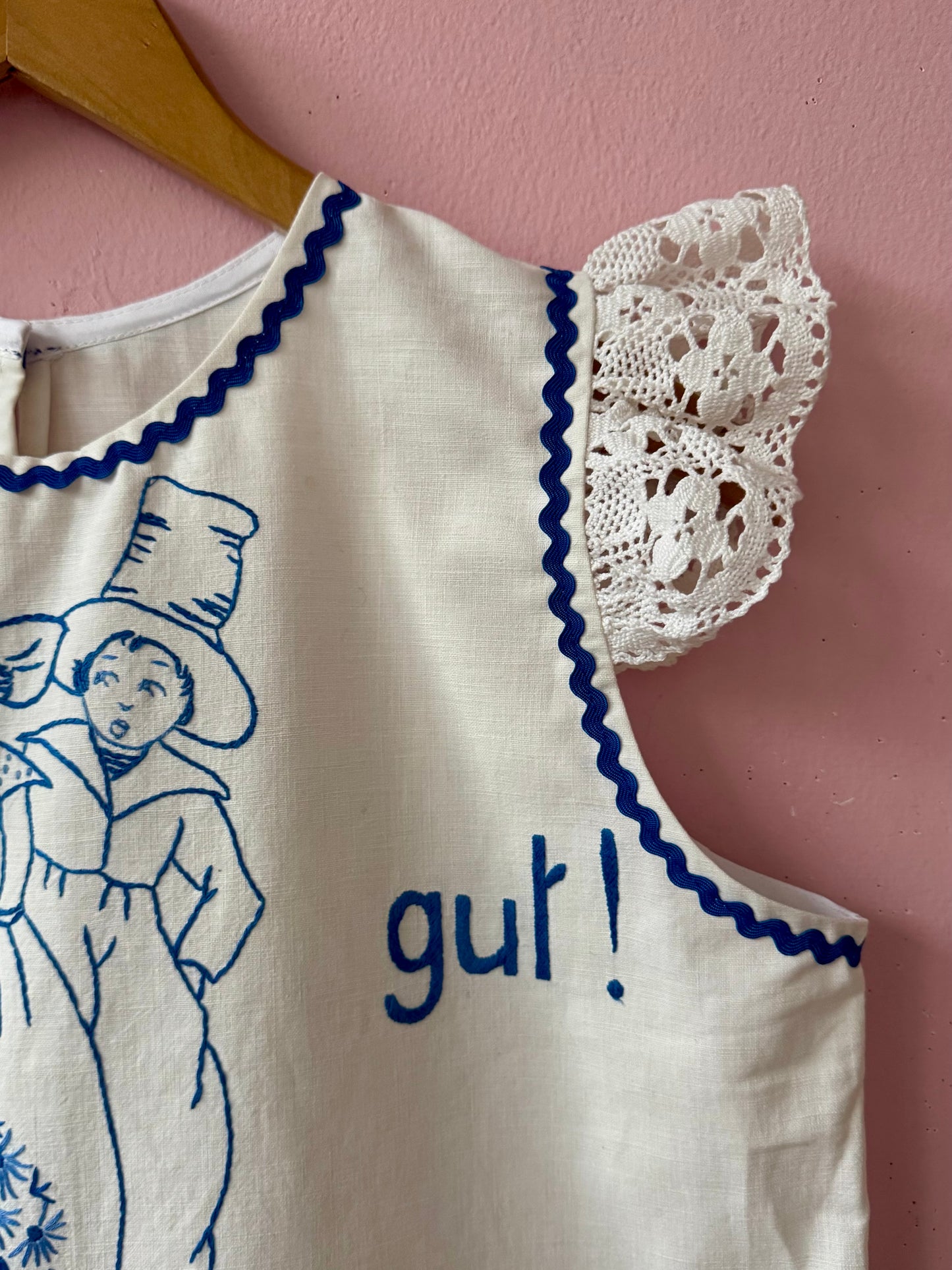 White top with blue hand embroidery