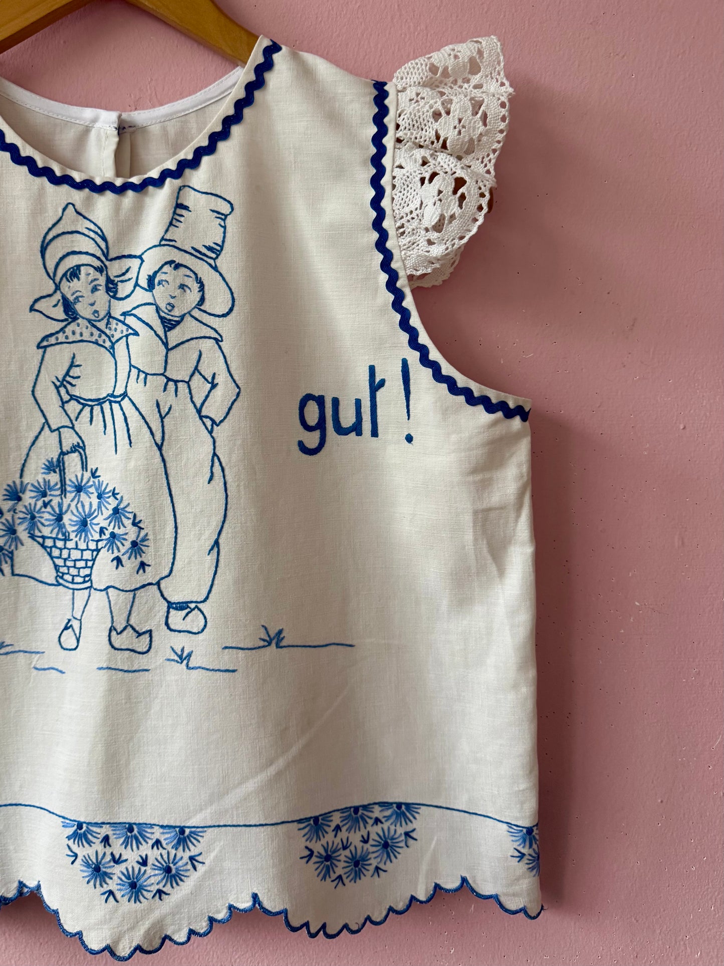 White top with blue hand embroidery