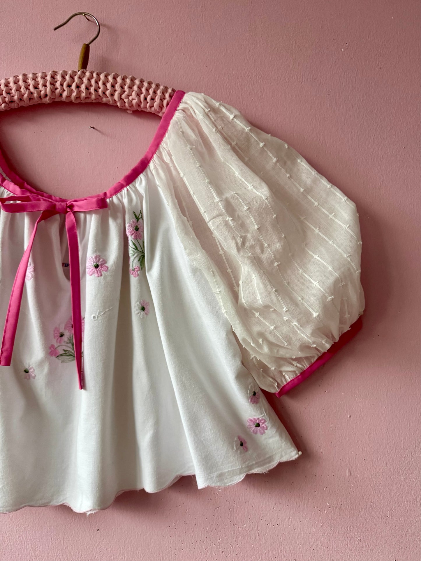 White blouse with pink binding
