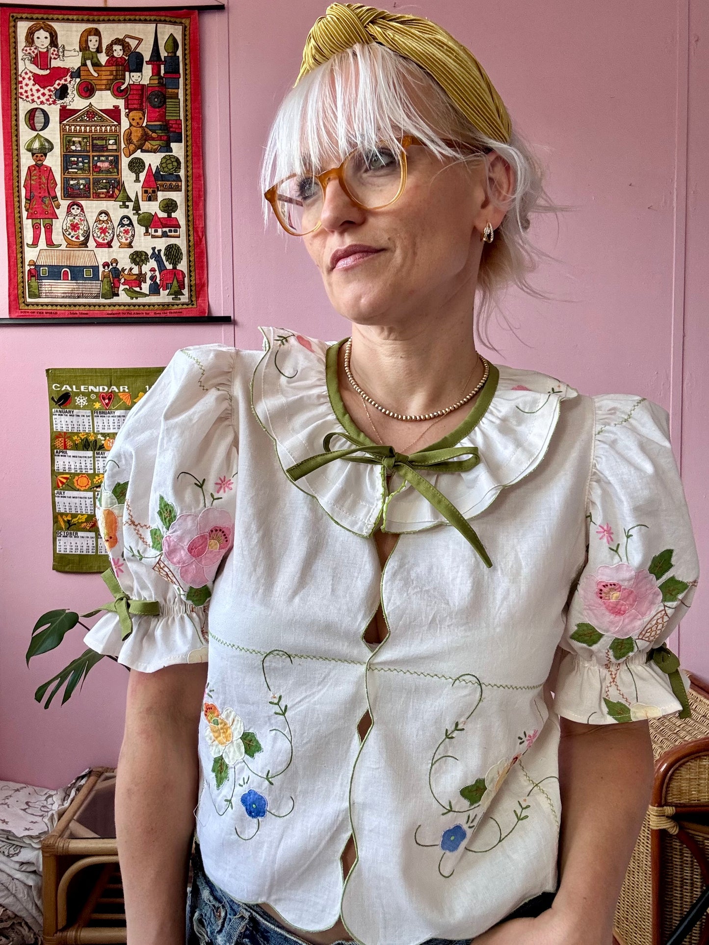 Cream blouse with floral appliqués