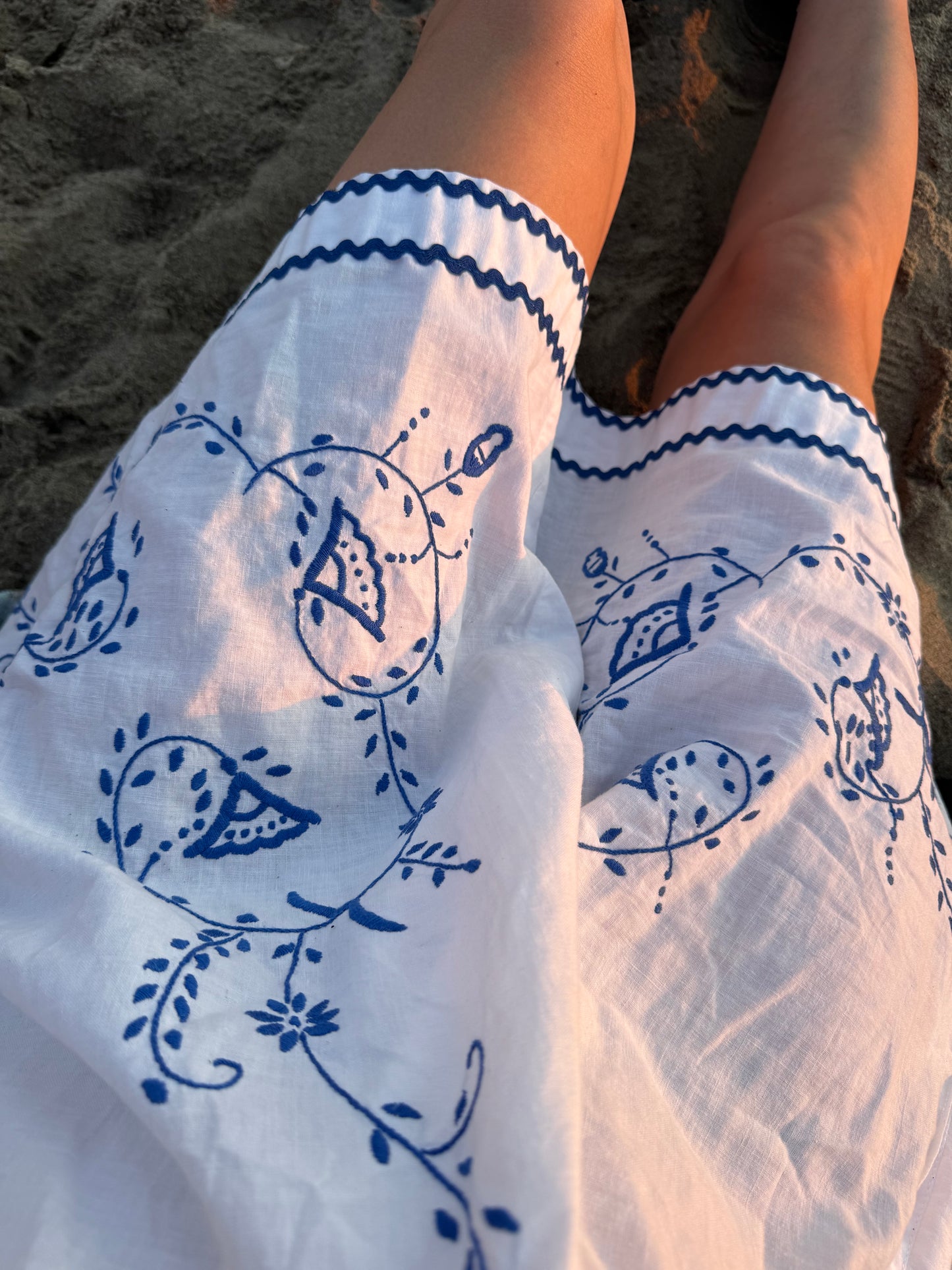 White mini dress with blue embroidery and blue bows