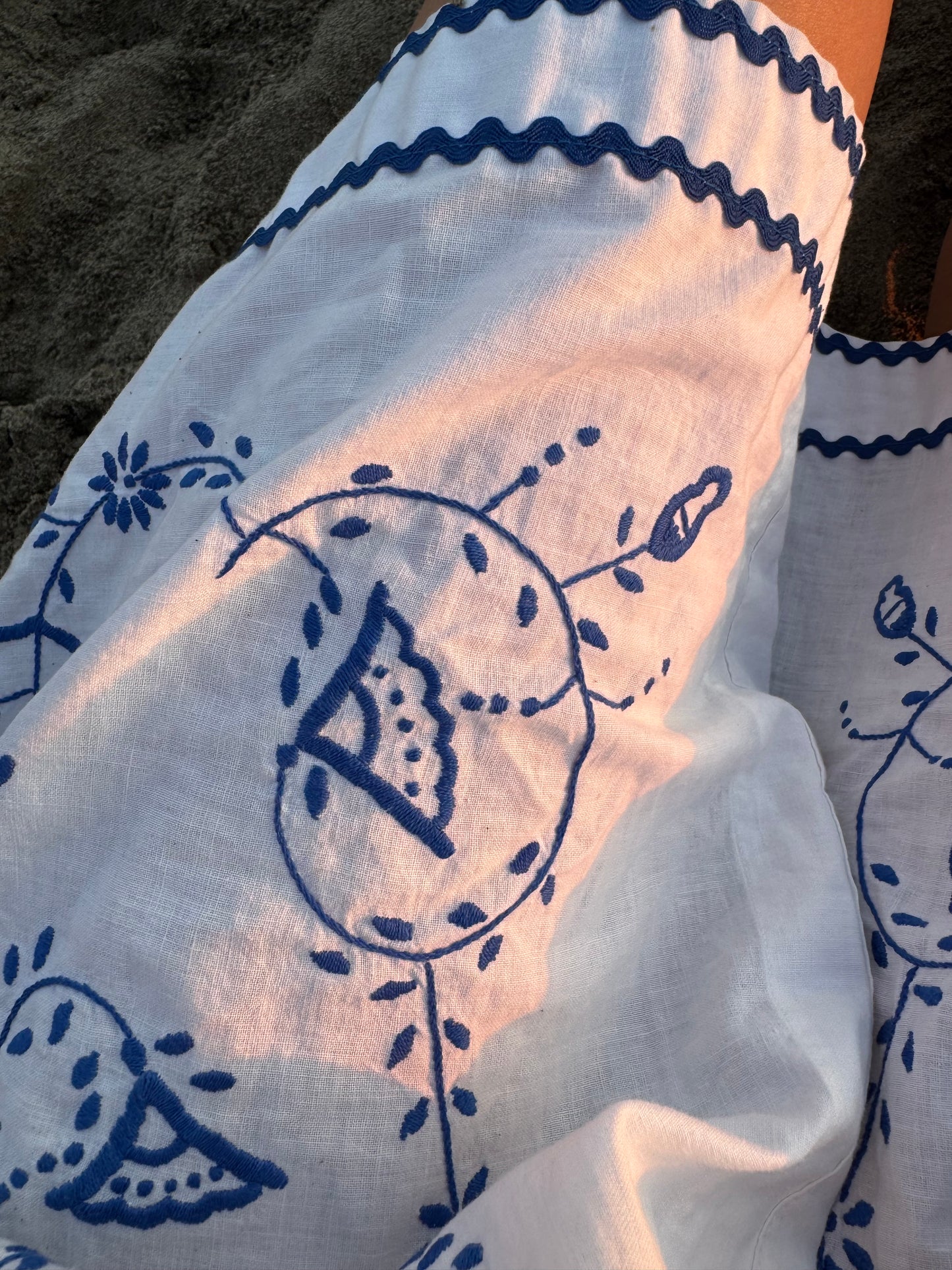 White mini dress with blue embroidery and blue bows